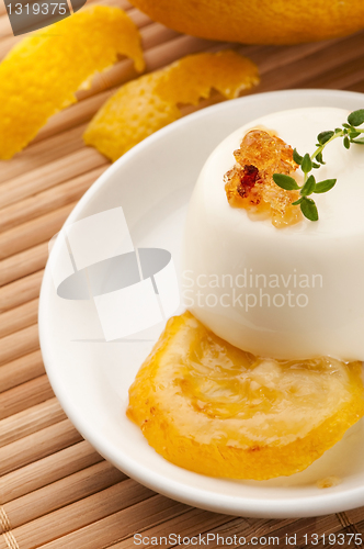 Image of Vanilla Panna Cotta Dessert with lemon and fresh herbs