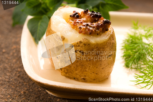 Image of Baked potato with sour cream, grain Dijon mustard and herbs