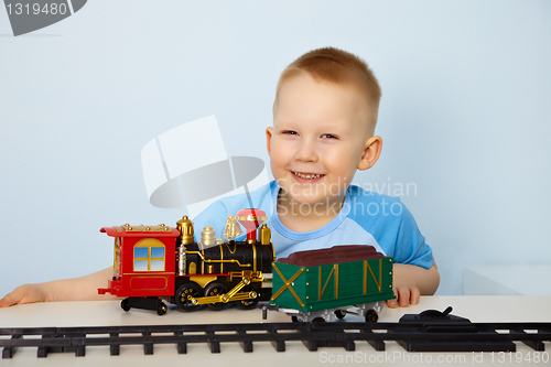 Image of Boy playing with toy railway