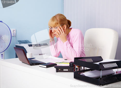 Image of Busy blonde in office workplace