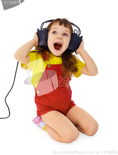 Image of Cheerful little girl sings the music