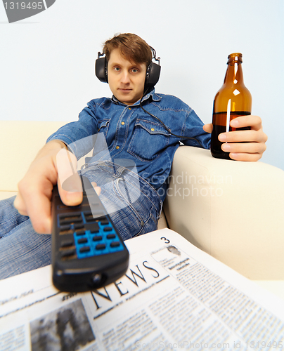 Image of Young man watching TV