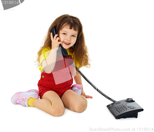 Image of Little girl talking on phone