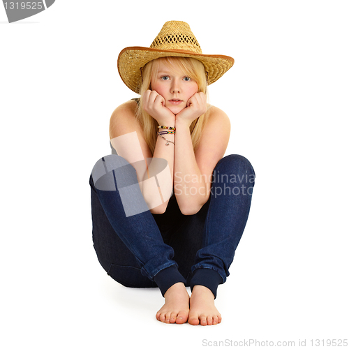 Image of Young blonde in straw hat sitting on floor