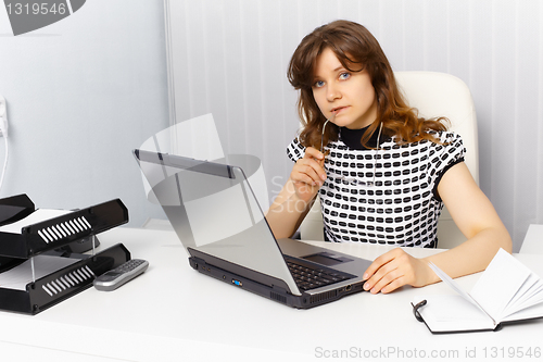 Image of Secretary working in office with laptop