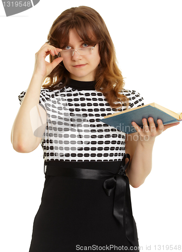 Image of Young beautiful woman in glasses with a book