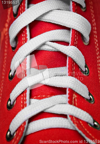 Image of Red old-fashioned gym shoe - lacing