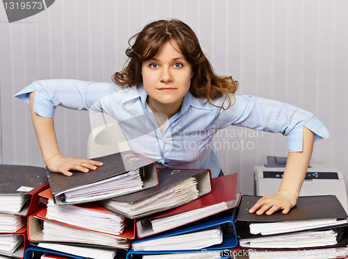 Image of Serious chief accountant at workplace with documents