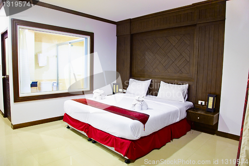 Image of Interior of a room in hotel. Large bed.