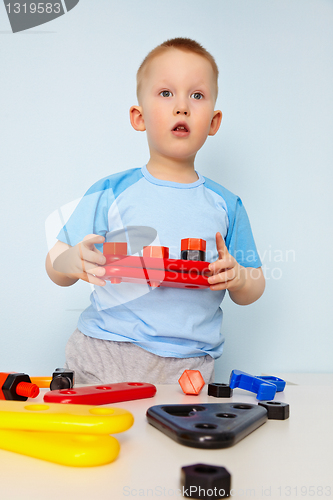 Image of Kid plays with toy parts