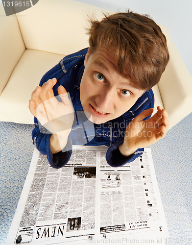 Image of Man shocked by bad news from newspaper