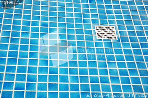 Image of Blue tile on bottom of a swimming pool