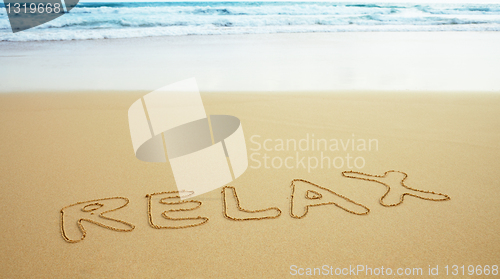 Image of Inscription on beach sand - relax