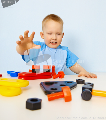 Image of Funny kid playing with color parts