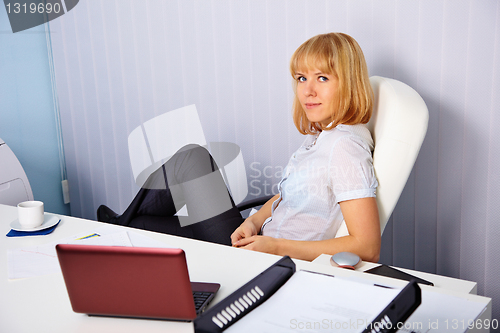 Image of Beautiful young blonde on office workplace