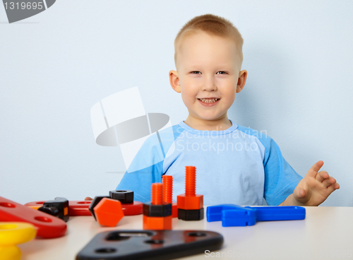 Image of Happy child playing with toys