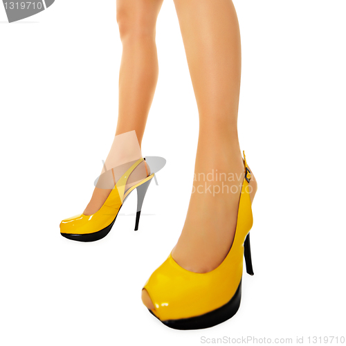 Image of Female legs in yellow high heels