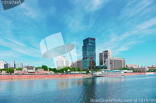 Image of High-rise building on riverbank. Urban landscape