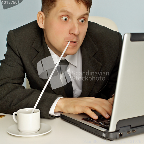 Image of Funny businessman drinking coffee and working