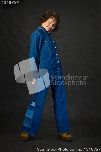 Image of Young woman in jeans on black