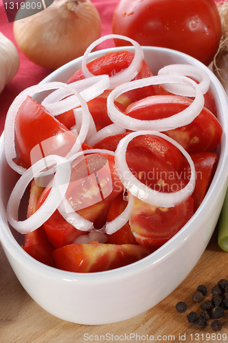 Image of fresh summer salad with tomatoes and onion rings