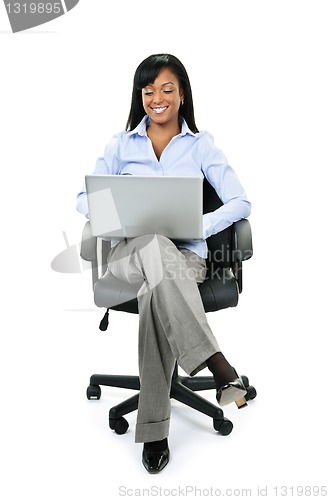 Image of Businesswoman sitting in office chair with computer