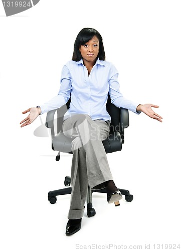 Image of Shrugging businesswoman in office chair