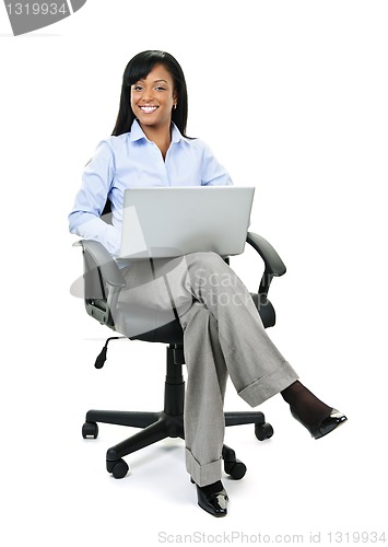 Image of Businesswoman sitting in office chair with computer