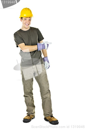 Image of Smiling construction worker pointing to the side