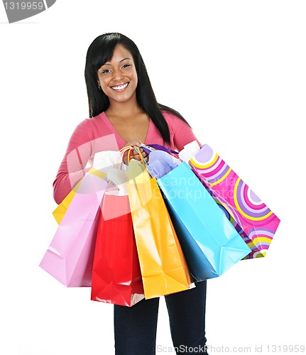 Image of Happy young black woman with shopping bags