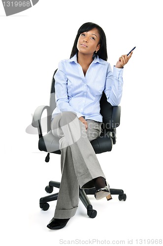 Image of Thinking businesswoman sitting on office chair