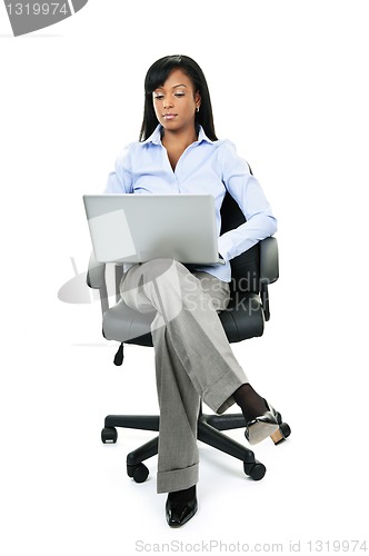 Image of Woman sitting in office chair with computer