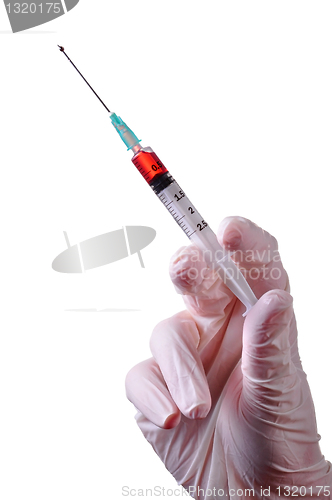 Image of Hand holding a syringe