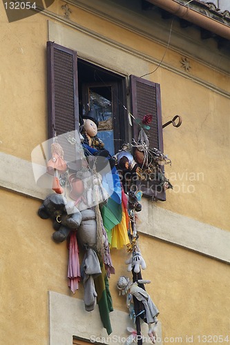 Image of Soft-toys hanging out of a window