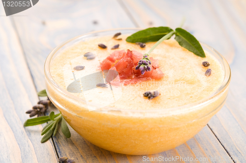 Image of fresh melon soup with parma ham and lavender flower