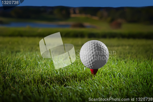 Image of Golf ball on red tee 