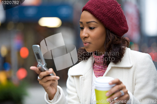 Image of Business Woman With a Phone and Coffee