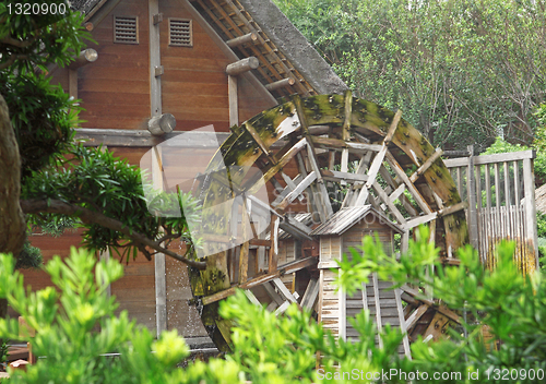 Image of water wheel on old grist mill in forest