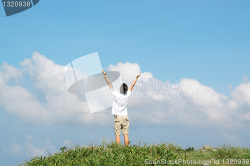 Image of Meeting of the sky. The man on high mountain with the hands lift