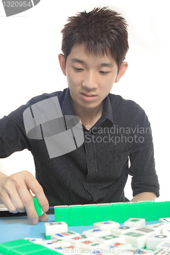 Image of Chinese man play Mahjong, traditional China gamble. 