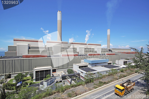 Image of coal fired power station and car moving