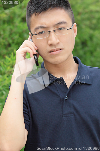Image of chinese man talking phone and worry