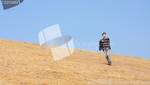 Image of man walking on the mountain