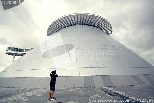 Image of man takeing photo of modern building