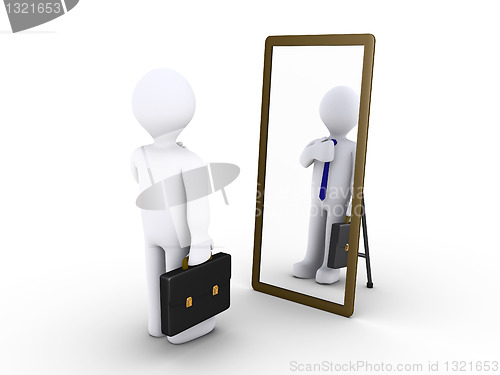Image of Businessman looking in the mirror