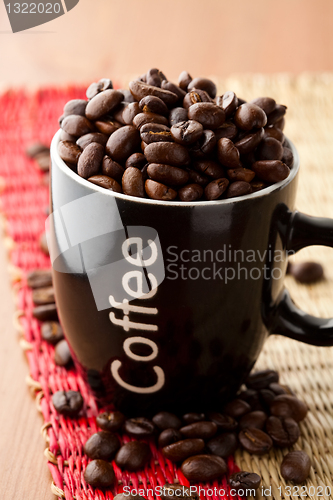 Image of Coffee mug with coffee beans