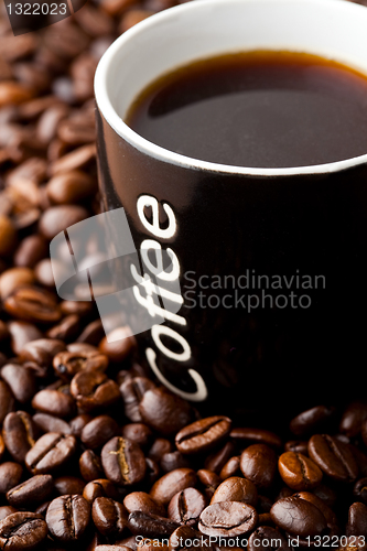 Image of Coffee mug with coffee beans