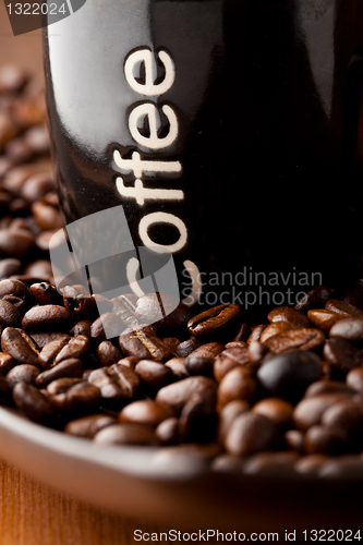 Image of Coffee mug with coffee beans