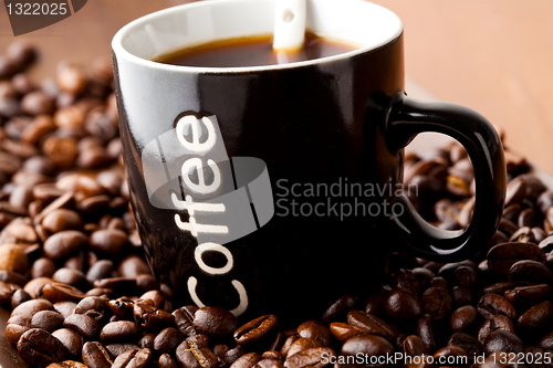 Image of Coffee mug with coffee beans