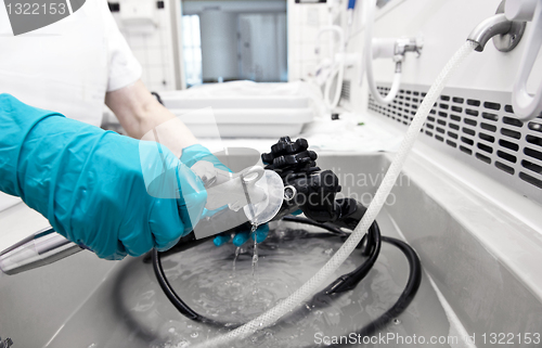 Image of hand with glove  is cleaning hospita equipment